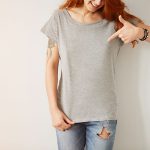 Women pointing her fingers to her shirt with her perfectly fitted bra.